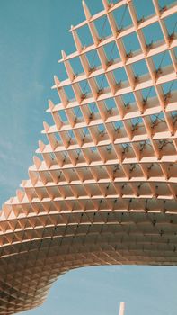 A view of the iconic Metropol Parasol structure in Seville, Spain, under clear blue skies.