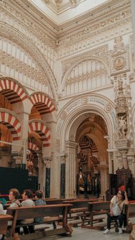 Intricate interior of the Mosque-Cathedral of Córdoba highlighting its historic arches and detailed carvings.