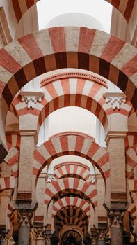 Stunning view of the iconic red and white arches inside the Mezquita in Córdoba, Spain.