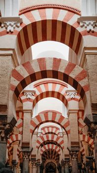 A stunning view of the iconic arches inside the Mezquita Cathedral in Córdoba, Andalusia, Spain.
