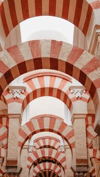 Striking red and white arches in the Mezquita Cathedral of Córdoba, Spain.