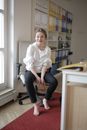 Barefoot female worker in modern office