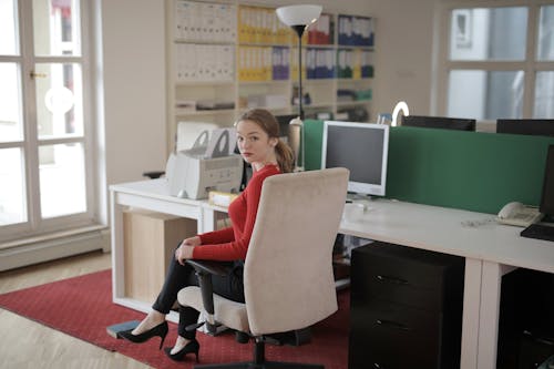 Free Woman Sitting on an Office Chair Stock Photo
