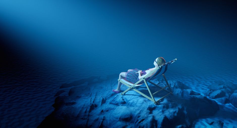 A surreal scene of a woman lounging underwater in a chair amidst serene blue tones.