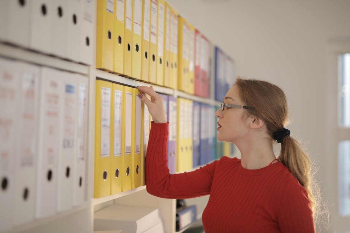 Free Woman Looking at Folders Stock Photo