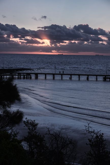 Beautiful sunset over the ocean with a pier in Melbourne, Australia.