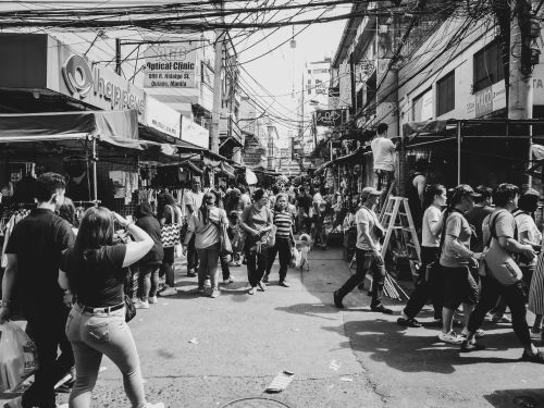 Free Bustling street scene in Quiapo, Manila, with vendors and shoppers captured in black and white. Stock Photo