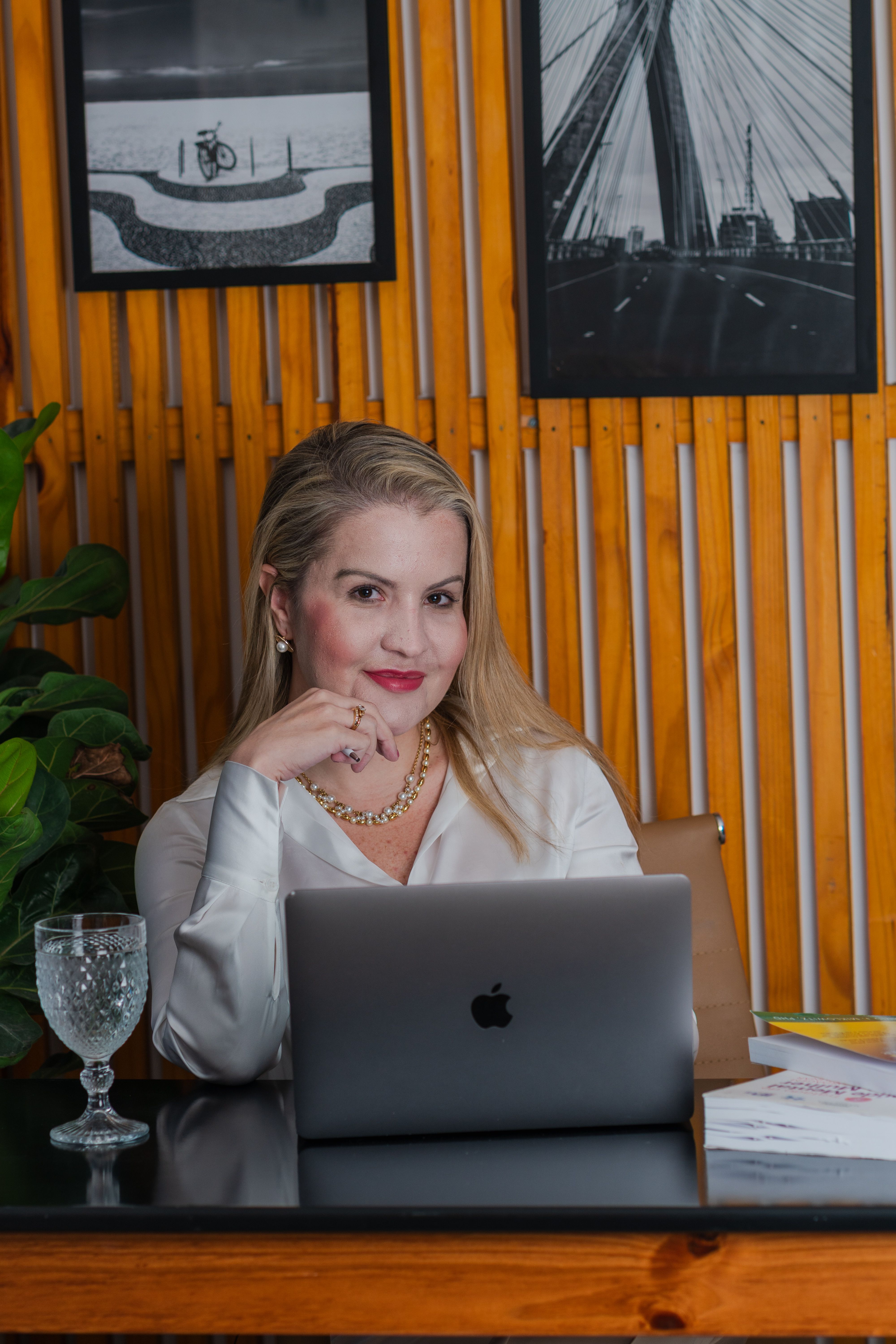 Elegant woman in a home office setting working on a laptop, conveying professionalism and focus.