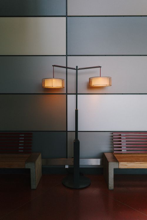 Free Stylish interior with dual lamps and minimalist benches in a modern setting. Stock Photo