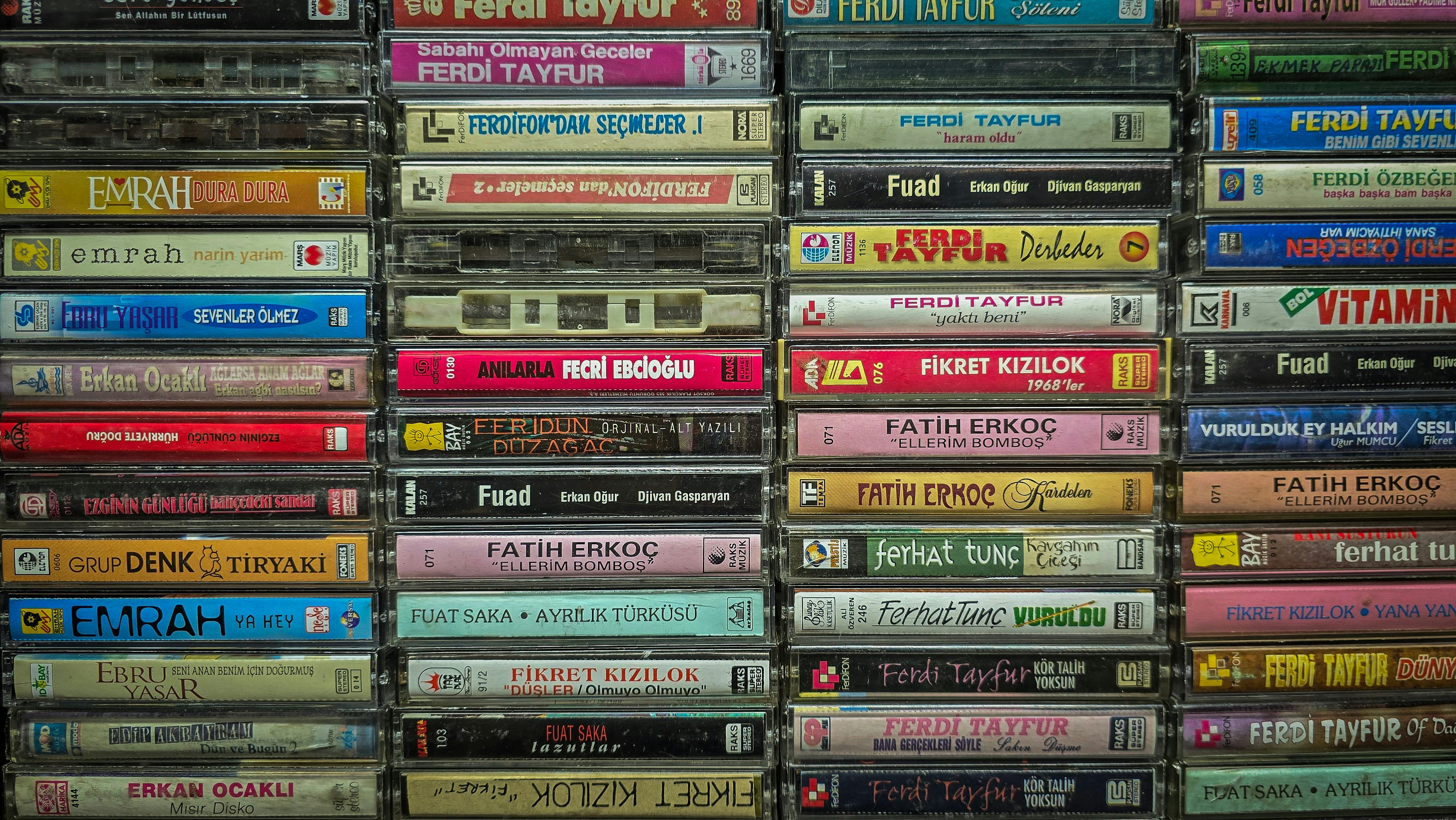 A colorful display of vintage Turkish music cassette tapes showcasing various artists from Türkiye.