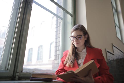 Woman in Red Blazer Reading Book