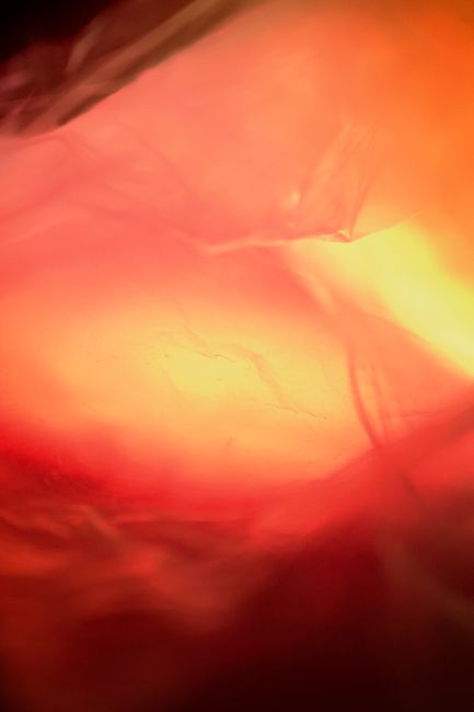 A vibrant abstract image of fabric with warm sunset tones, creating a dramatic effect.