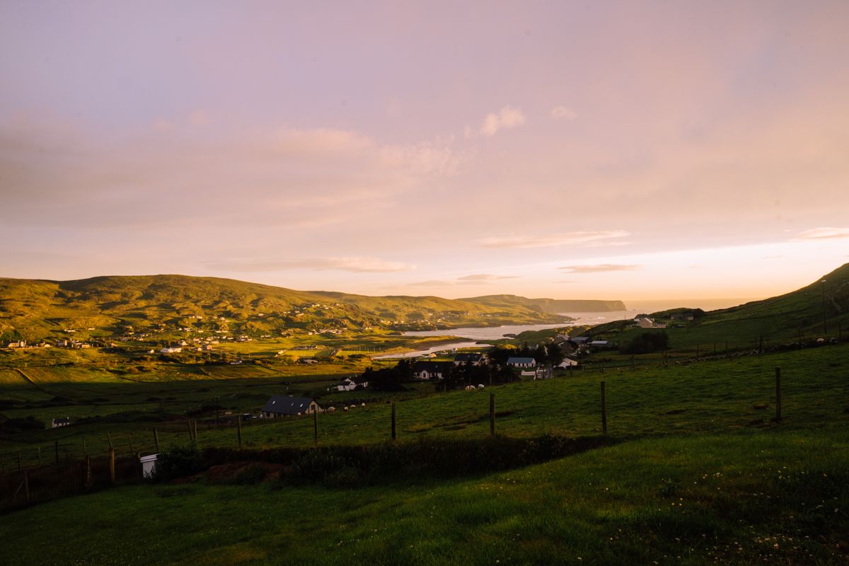 Green Donegal hills and coast at sunset