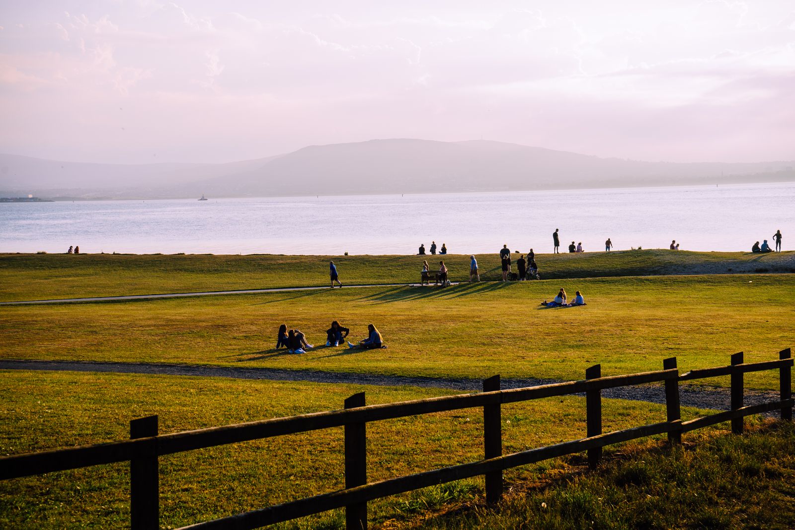 People relaxing by Donegal Bay, enjoying a afternoon with views