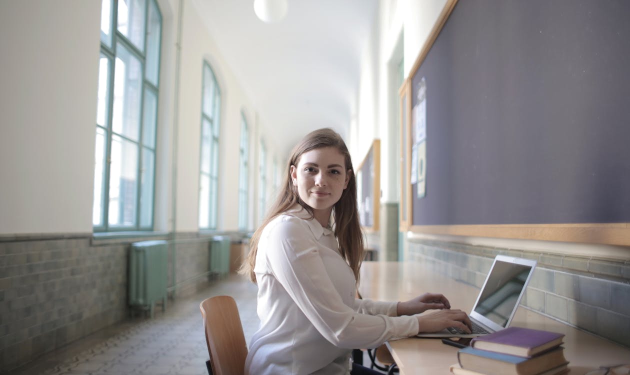 Female student typing on laptop preparing for DET Interactive Writing task