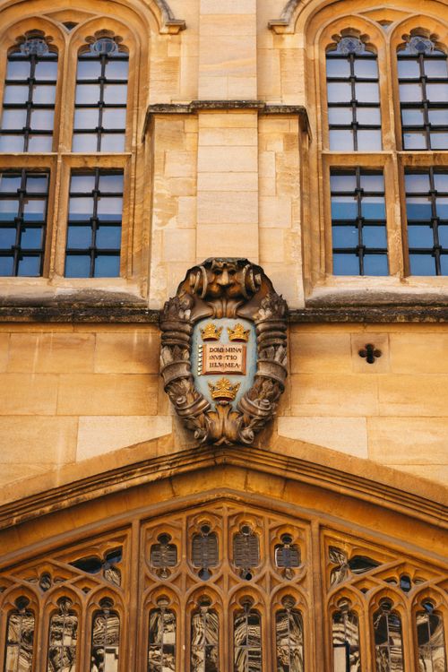 Free Detailed view of an ornate stone crest on a historic building in Oxford, UK. Stock Photo