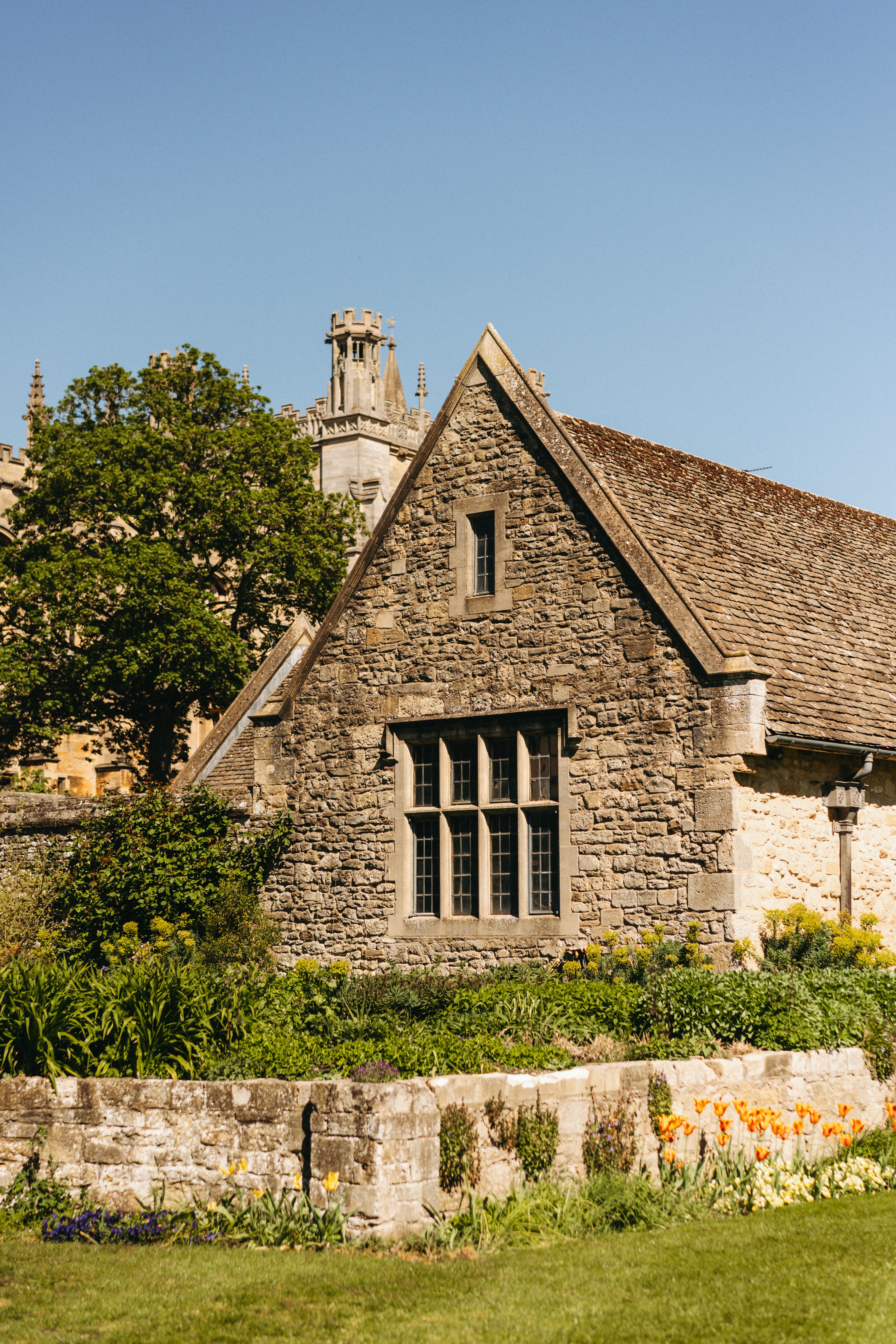 A picturesque stone building with classic architecture in Oxford, UK, on a sunny day.
