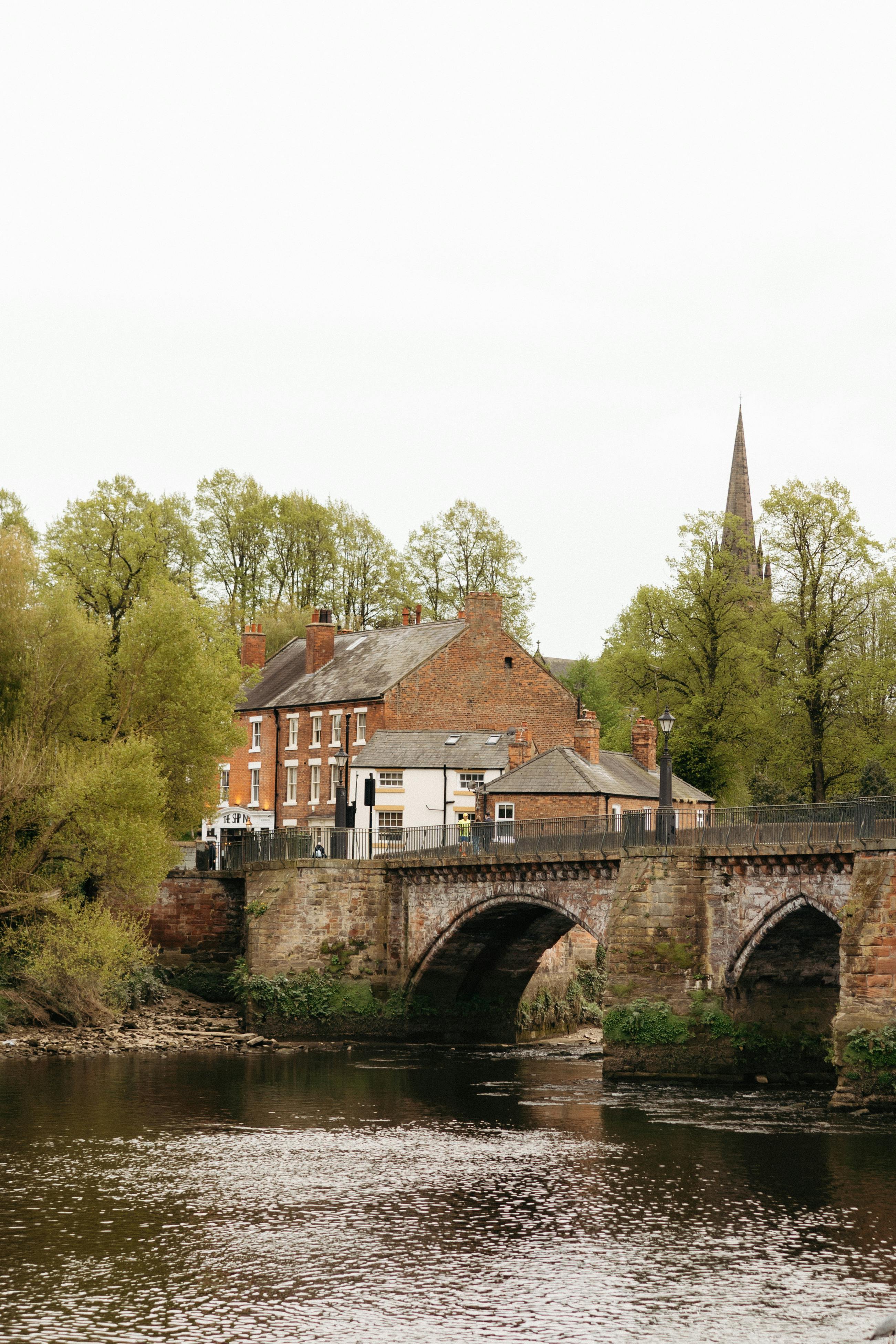 Charming view of a historic bridge and buildings in Chester, UK showcasing architectural heritage.
