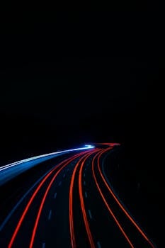 Long exposure of light trails on a highway at night, creating a mesmerizing visual in Ilsfeld, Germany.