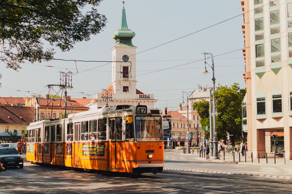 Yellow tram moving through a street in Budapest, Hungary