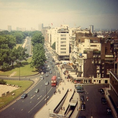 Free A nostalgic view of 1960s London cityscape with busy streets and classic architecture. Stock Photo
