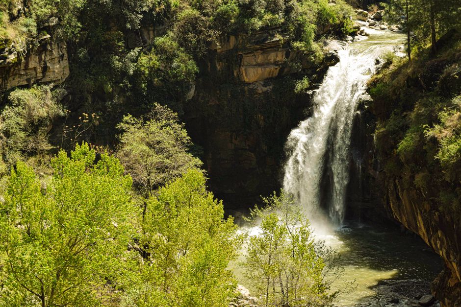 Stunning waterfalls in Ourika Valley, Morocco, with lush greenery and traditional Berber villages