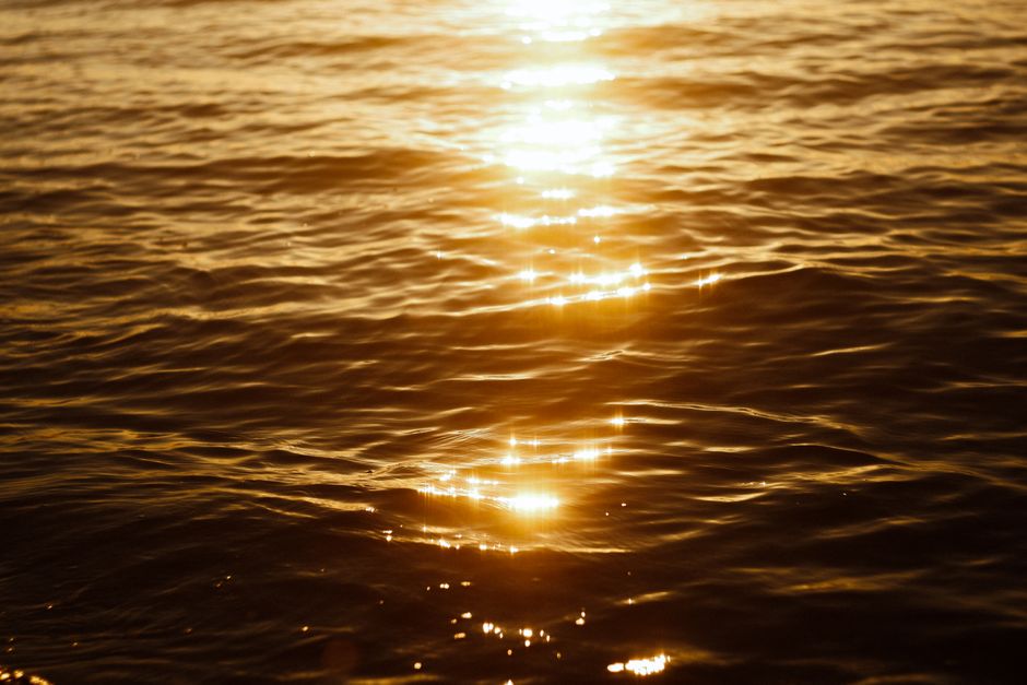 Capture of golden sunlight shimmering on calm sea waves at sunset in Egypt.