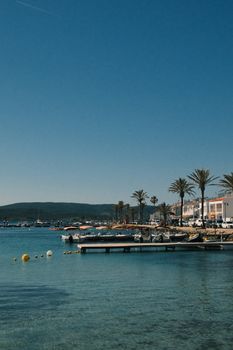 View of Mahón harbor in Menorca with clear blue skies and docked boats. Perfect summer scene.