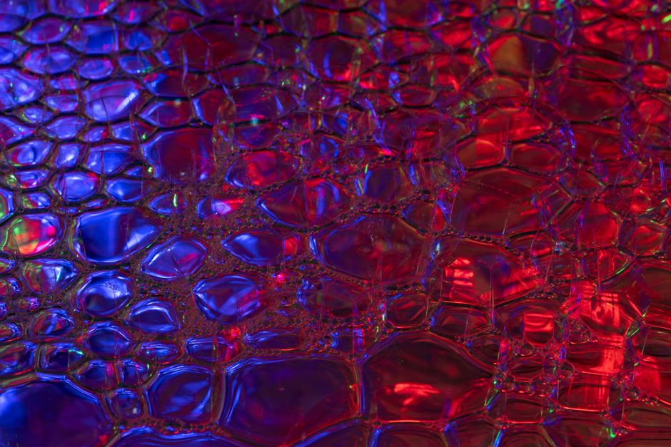 A vivid abstract bubble pattern showcasing red and blue hues, creating a modern and glossy effect.