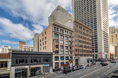 Free Morning view of a bustling urban street with historic and modern architecture, capturing city life. Stock Photo