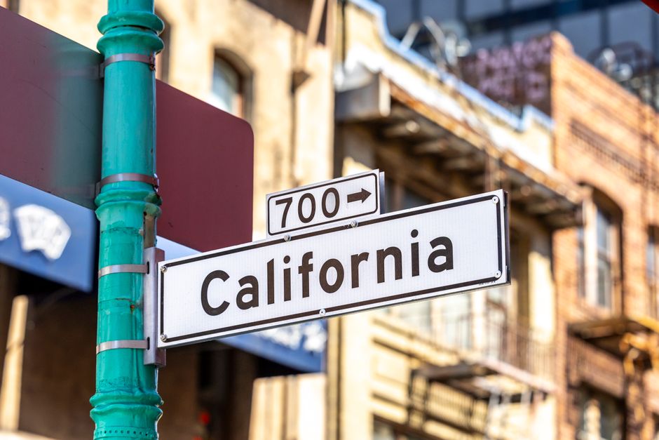 California street sign representing the high California 13.3% tax burden and cost of living driving residents to consider moving abroad
