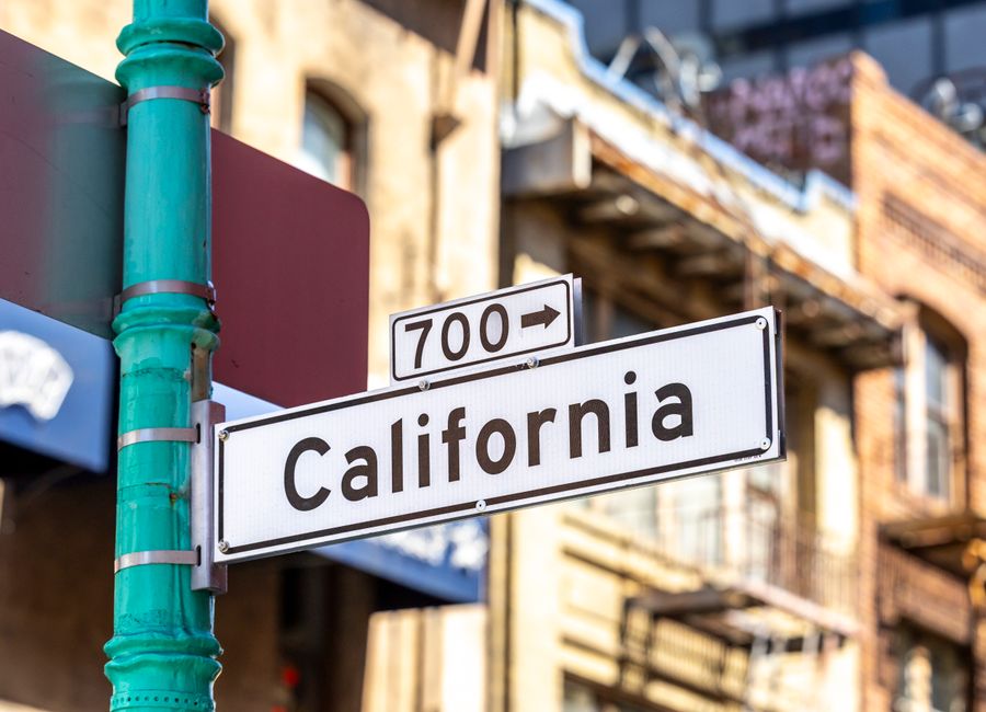 Street sign for California in an urban environment, highlighting city life.