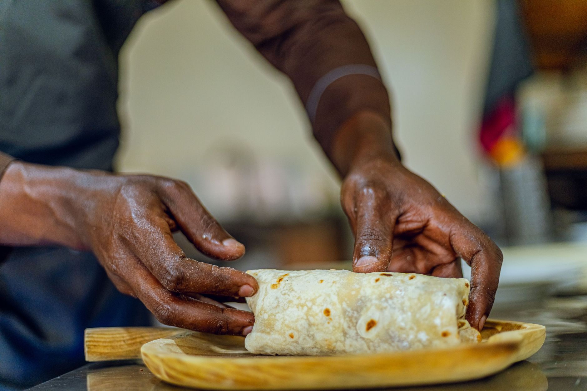 A burrito being prepared in a Chipotle kitchen, reflecting the transaction growth that drove the company's Q2 results.