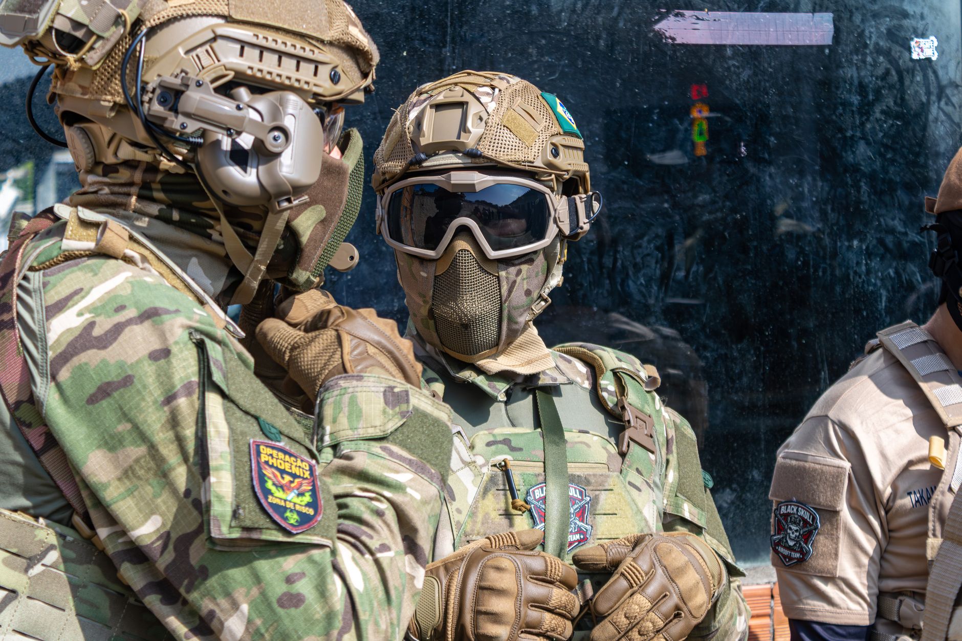Military personnel in full tactical gear prepare for a mission, showcasing advanced equipment and communication devices.