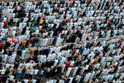 Free A diverse crowd of people gathered for a mass prayer in Egypt, seen from above. Stock Photo