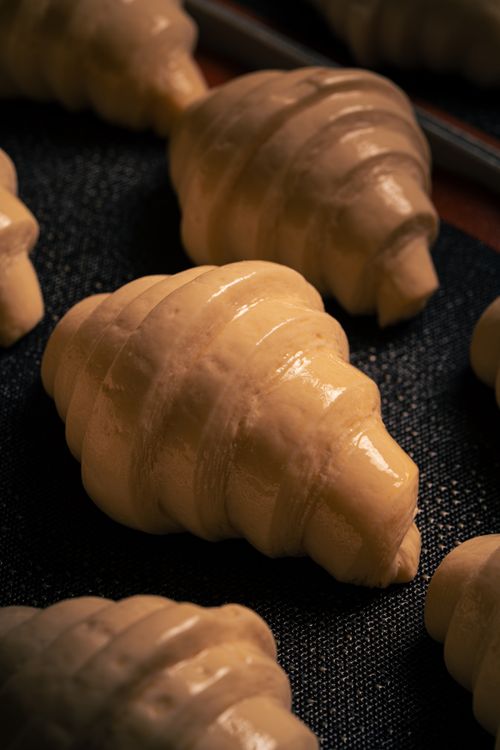 Free Fresh unbaked croissants ready for the oven. Perfect for a bakery setting. Stock Photo