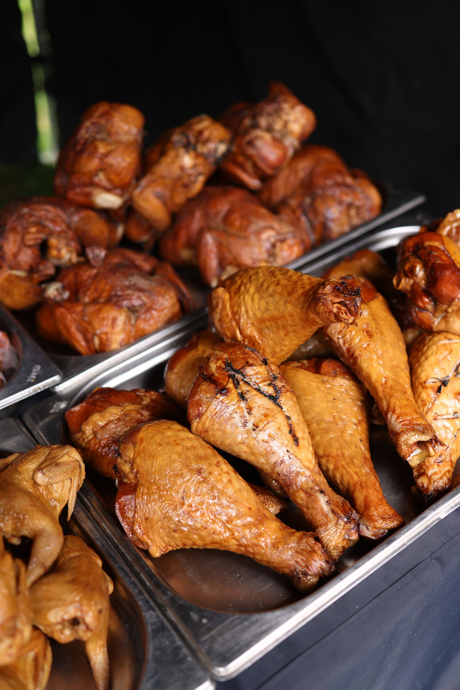 Trays of smoked chicken and turkey legs ready to serve