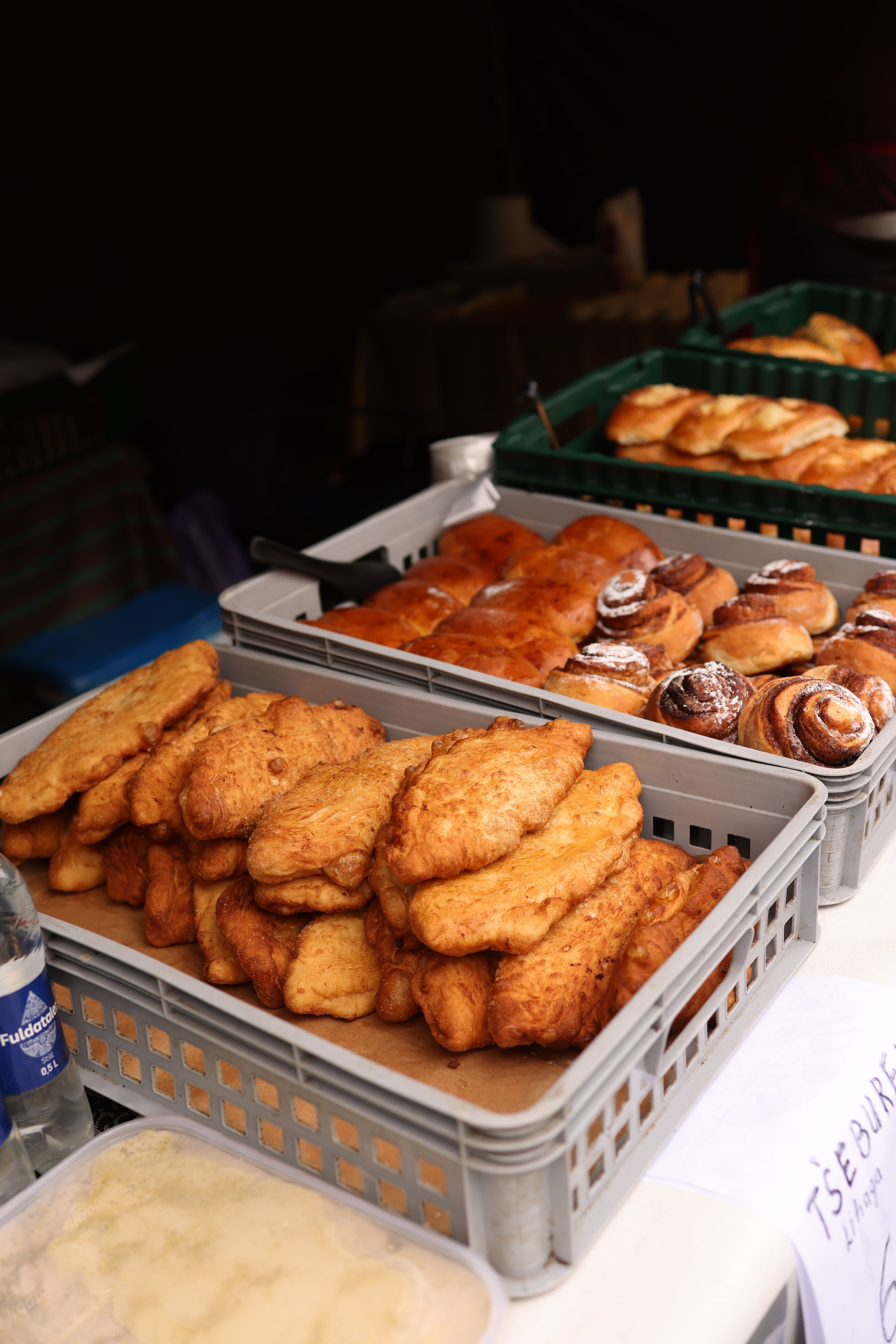 Delicious variety of pastries and breads on a market stall, offering a tasty selection for customers.