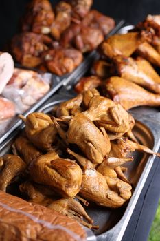 A variety of smoked poultry showcased in a market setting.