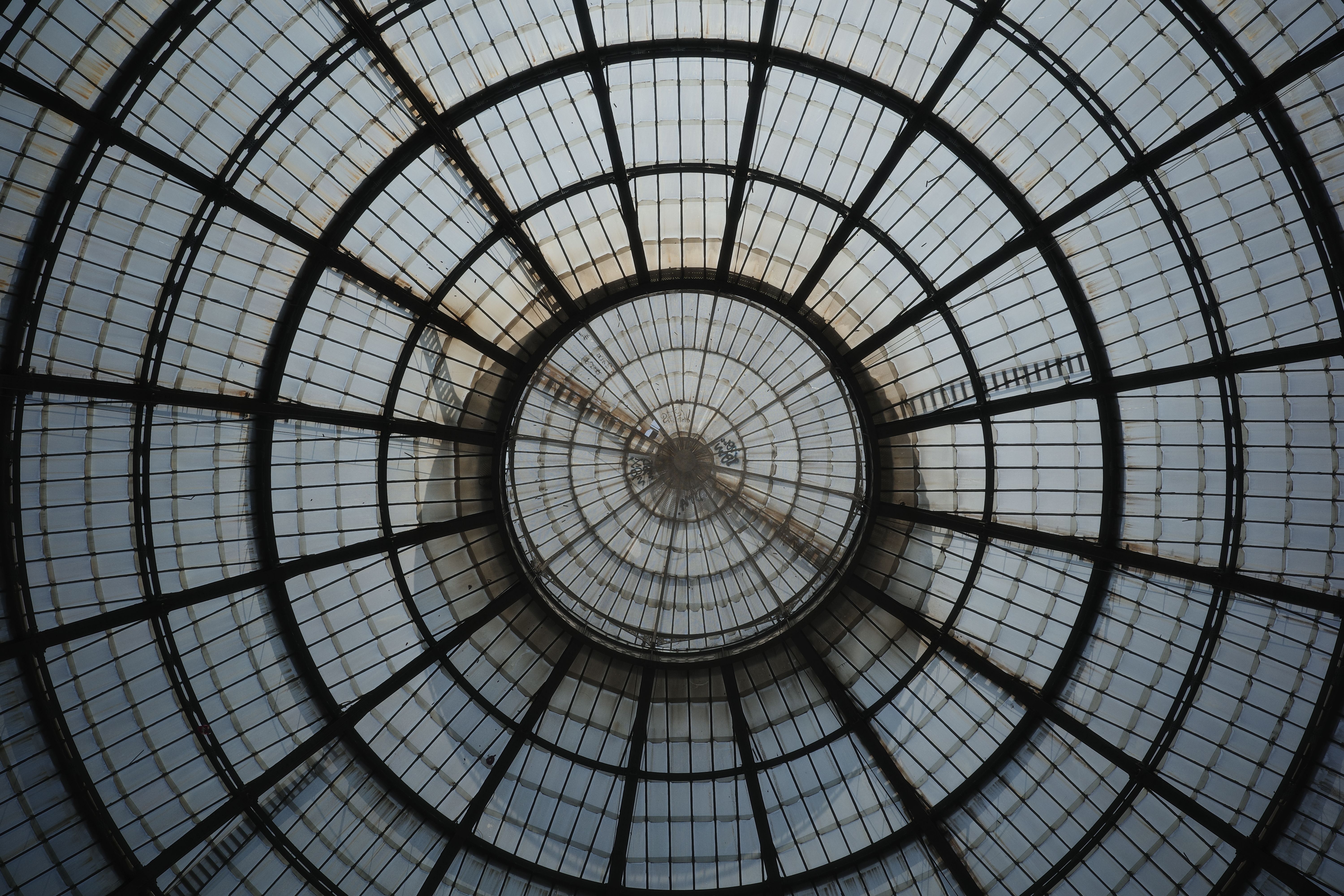 Stunning view of the architectural glass dome in Galleria Vittorio Emanuele II, Milano.