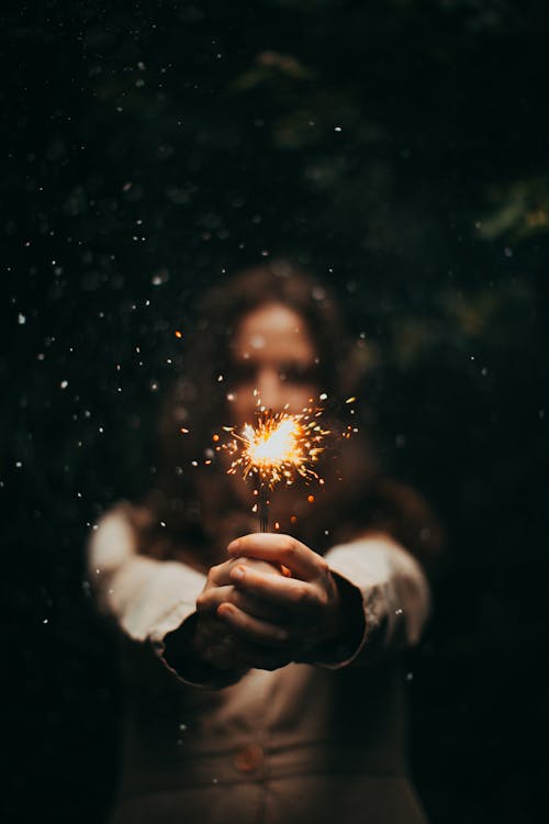 Free Person Holding Lighted Sparkler during Nighttime Stock Photo