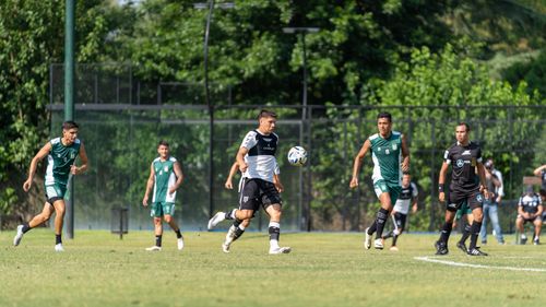 Free Players in action during a soccer match on a sunny day, showcasing teamwork and skill. Stock Photo
