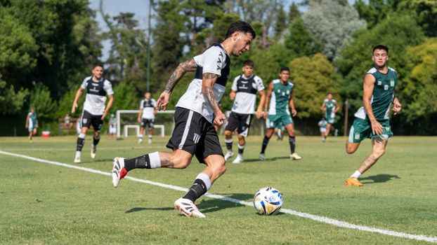 Dynamic action shot of a soccer match with athletes competing outdoors.