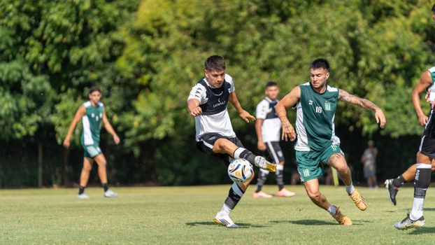 Action-packed soccer match with players competing aggressively on a sunny day.