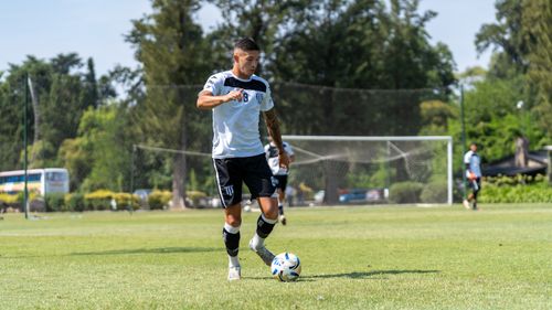 Free A football player trains on a sunny day during soccer practice on a field. Stock Photo