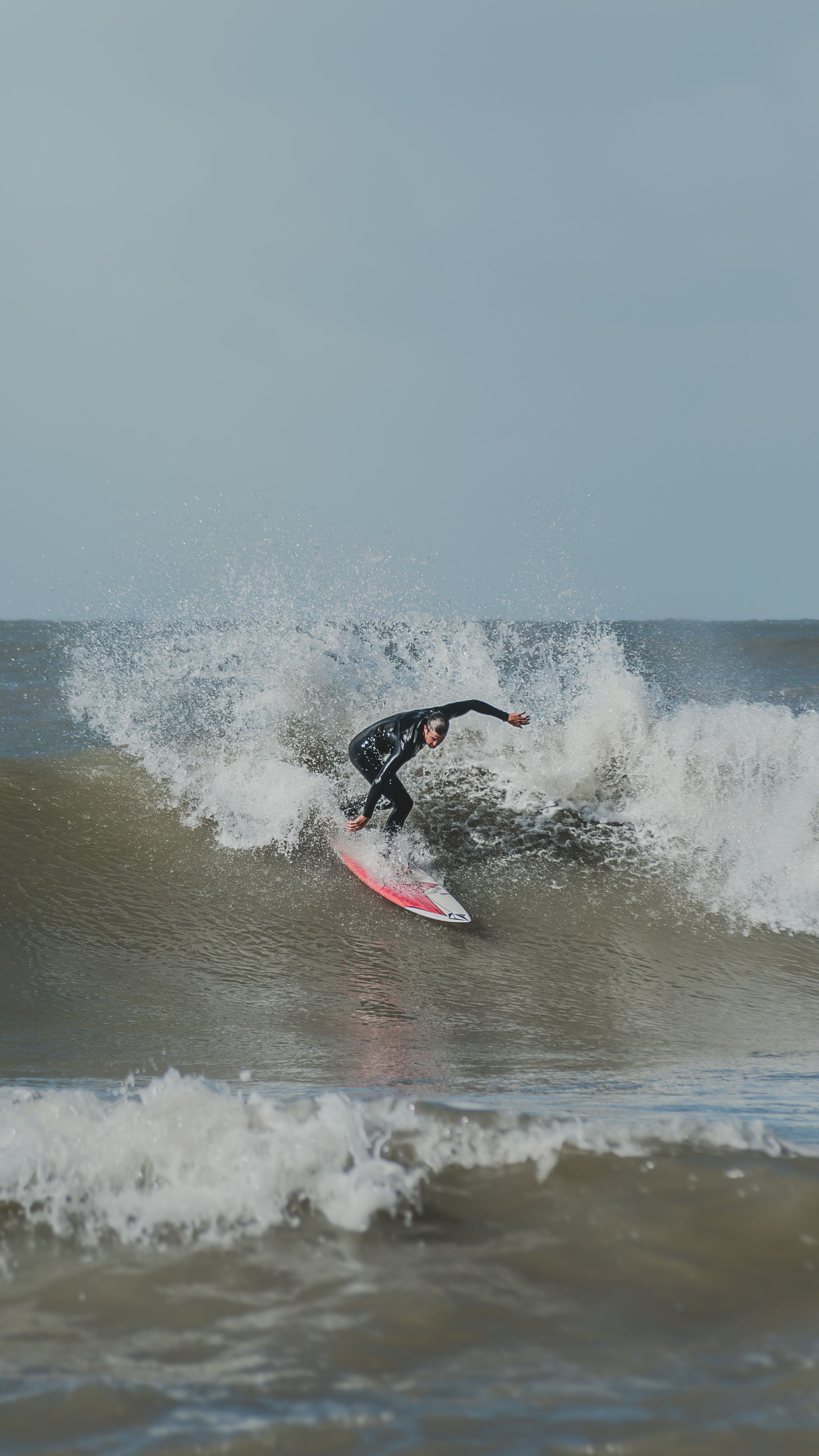 Professional surfer skillfully rides a large ocean wave