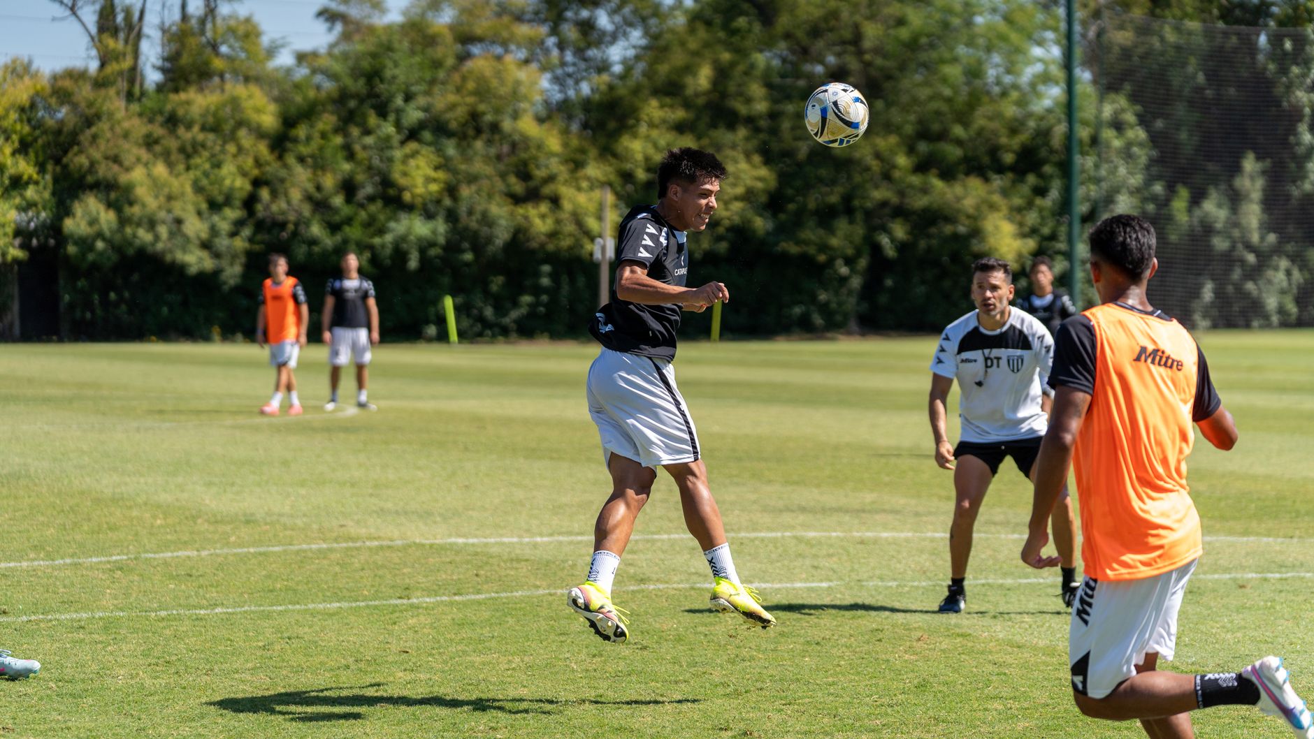 Neymar training individually beside Brazil teammates on a World Cup practice pitch