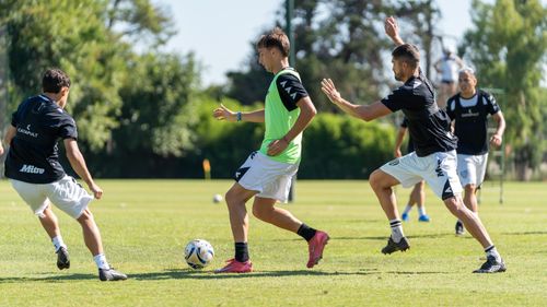 Free Dynamic soccer players in action during an outdoor training session on a sunny day. Stock Photo