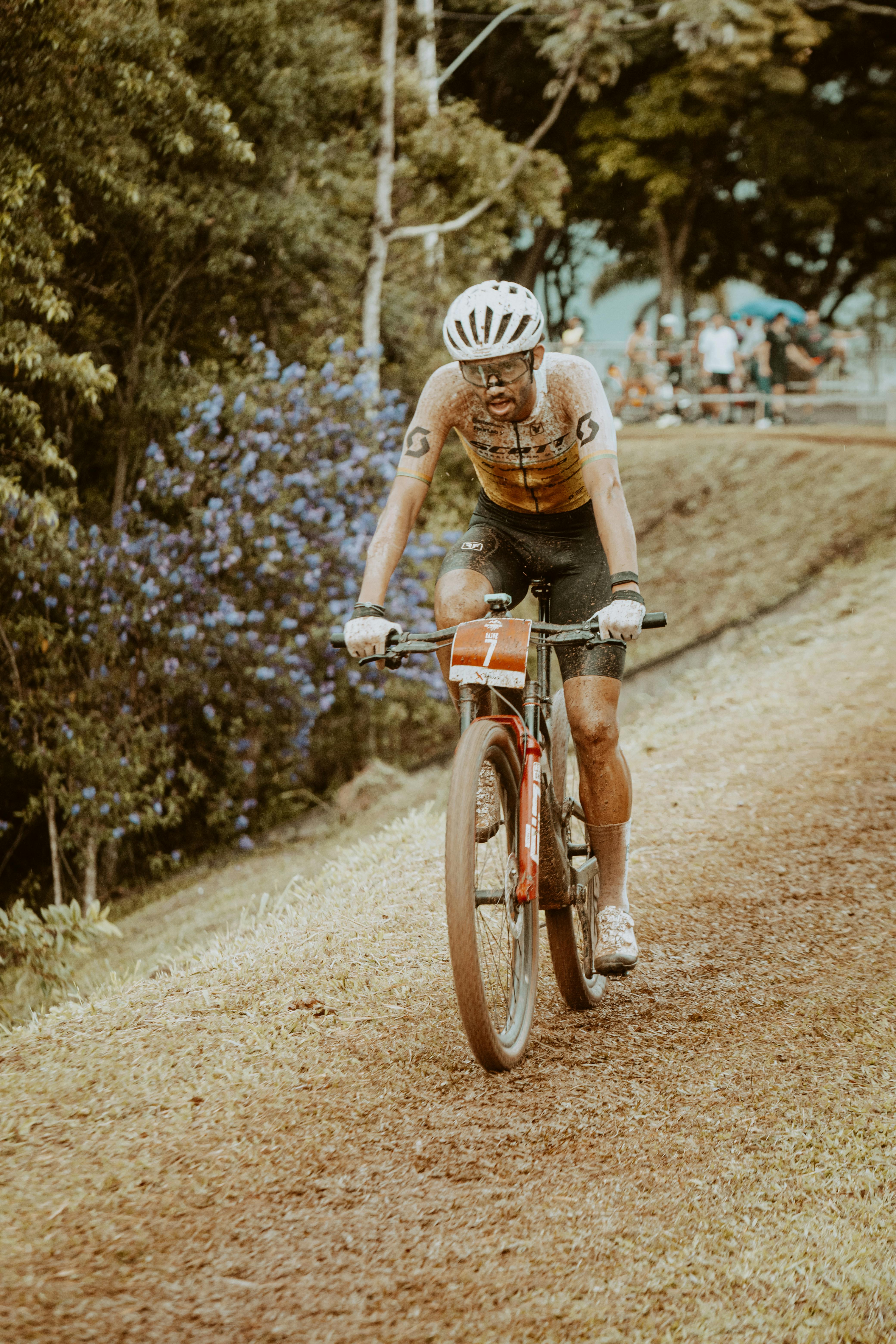Competitive male cyclist on rugged terrain during a high-intensity off-road bike race.