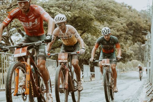 Free Intense mountain bike race with cyclists battling through rain on a challenging outdoor track. Stock Photo